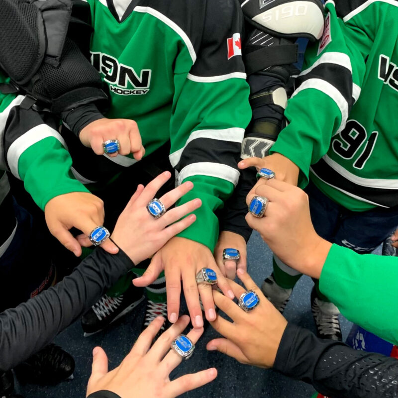 Kids showing off championship rings